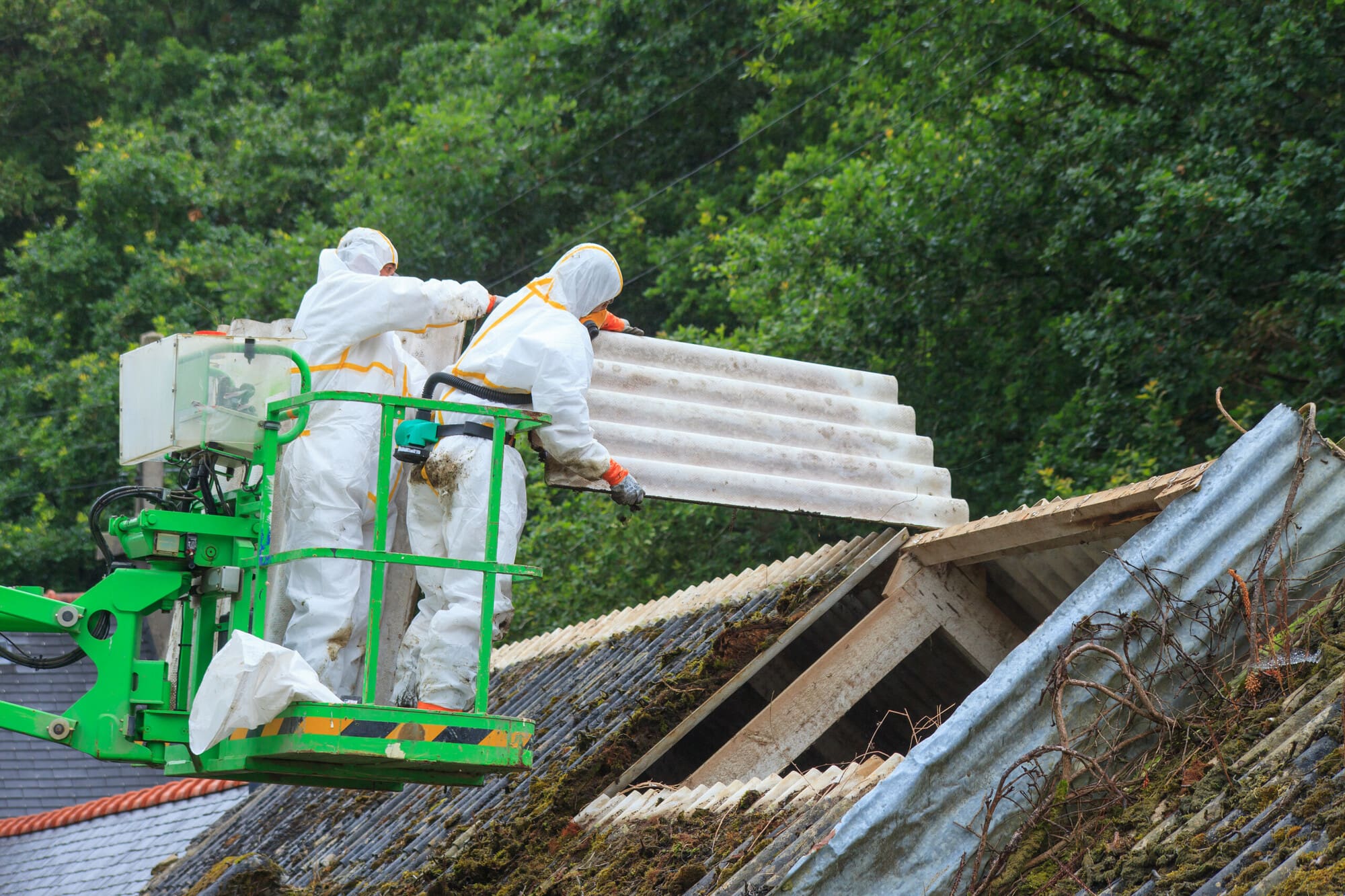 Licensed asbestos disposal team loading asbestos waste in London